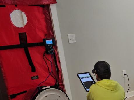 Man Running TEC Blower Door with Tablet 